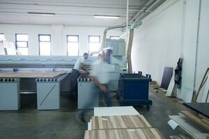 operai in una fabbrica di mobili in legno foto