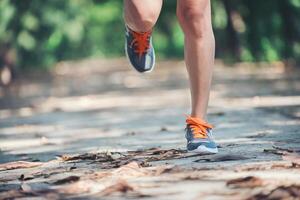 gambe di una donna sana durante il jogging al mattino al parco. foto