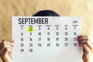 un' donna Tenere agosto calendario con segnato lavoro duro e faticoso giorno. 2 ° settembre segnato a 2019 calendario foto