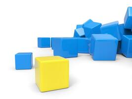 giallo cubo sta su di il mucchio di blu cubi foto