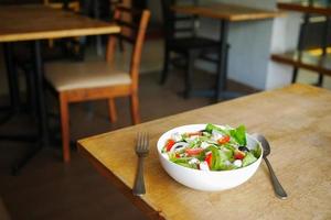 insalata greca in una ciotola su un tavolino da bar.