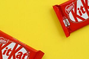 kit Kat cioccolato bar nel rosso involucro bugie su giallo sfondo. kit Kat creato di Rowntree di York nel unito regno e è adesso prodotta globalmente di annidarsi foto