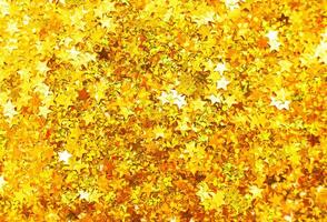 luccicante sfondo di d'oro paillettes nel modulo di stelle avvicinamento. scintillare festivo struttura. foto