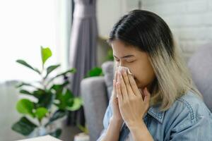 asiatico donna starnuti a partire dal camera polvere. allergie. foto