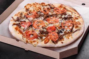 pizza calda fresca con carne, funghi, formaggio e pomodori foto