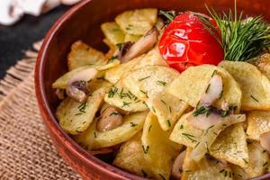 Spicchi rustici di patate con formaggio, erbe e salsa di pomodoro foto