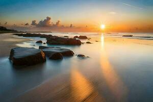 il sole sorge al di sopra di il oceano e rocce su il spiaggia. ai-generato foto