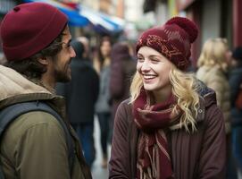 un' coppia Tenere mani mentre ridendo e condivisione un' cappello o Beanie nel inverno città foto