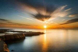 tramonto al di sopra di il oceano con rocce e acqua. ai-generato foto