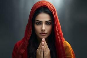 un' immagine di un' bella indiano donna con sua mani piegato nel preghiera nel davanti di il telecamera, ai generativo foto