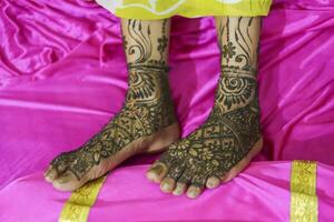 indiano sposa mostrando piedi mehndi design sua nozze cerimonia foto