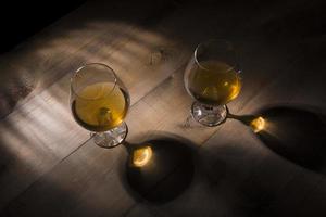 bicchiere di brandy o cognac sul tavolo di legno foto