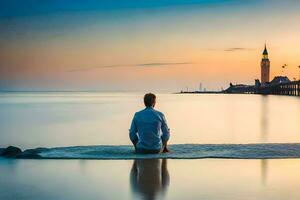 un' uomo seduta su il spiaggia a tramonto. ai-generato foto