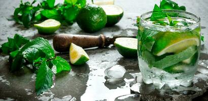 fresco Mojito con lime e menta su il pietra tavolo. foto