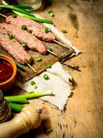 crudo kebab con pomodoro salsa e verde cipolle. foto