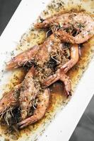 gamberi saltati con erbe all'aglio e salsa di aceto balsamico nel ristorante di pesce siciliano