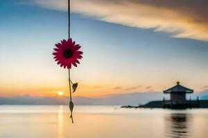 un' fiore sospeso a partire dal un' corda al di sopra di il acqua. ai-generato foto