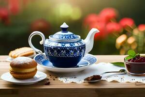 un' blu e bianca teiera si siede su un' tavolo con un' tazza di tè e un' Pasticcino. ai-generato foto