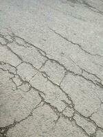 pavimentata e Cracked strada struttura o sfondo foto