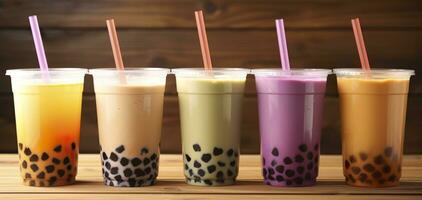plastica tazze di diverso gustoso bolla tè su di legno sfondo. generativo ai foto