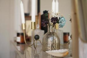 arredamento d'interni per la casa. vaso di vetro con fiori secchi, vaso e candela foto