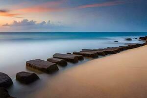 un' lungo esposizione fotografia di un' spiaggia con rocce e sabbia. ai-generato foto