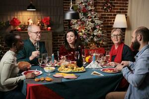 vecchio persona a festivo cena con amici godendo Natale celebrazione a casa, posto pieno con decorazioni e natale albero. nonna preparazione tradizionale cibo per vacanza stagione evento. foto