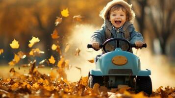 un' giovane bambino equitazione un' poco auto attraverso il le foglie nel il autunno foto