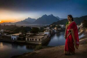 un' donna nel un' rosso sari sta su un' collina prospiciente un' fiume e montagne. ai-generato foto