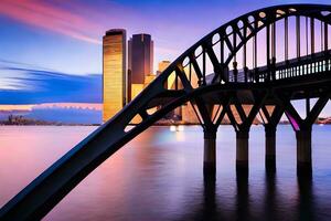 un' ponte spanning al di sopra di acqua a tramonto con alto edifici nel il sfondo. ai-generato foto