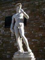 scultura copia di il famoso david di michelangelo nel piazza della signoria , illuminata dal sole su pietra parete sfondo, Firenze, Toscana, Italia, Europa foto