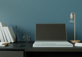 una stanza di lavoro con un laptop con una lampada posta sul tavolo. foto