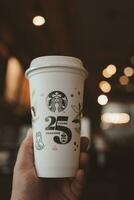 bangkok, Tailandia - ottobre 16, 2023 uomo Tenere riutilizzabile tazza, 25 anniversario, Starbucks Tailandia, ottenere 1 gratuito foto