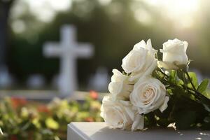 bianca fiori nel davanti di un' pietra sepolcrale a un' cimitero con tramonto.funerale concetto ai generato foto