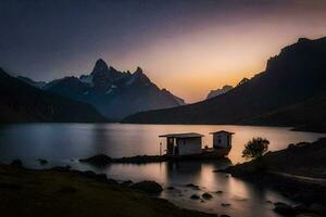 un' piccolo Casa si siede su il riva di un' lago a tramonto. ai-generato foto