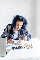 designer che lavora con tavolozze di colori e laptop nel suo studio foto