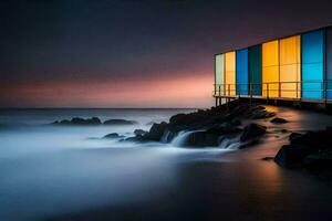 un' colorato edificio si siede su il riva di il oceano. ai-generato foto