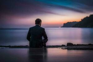 un' uomo nel un' completo da uomo si siede su il spiaggia a tramonto. ai-generato foto