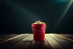 un' rosso secchio pieno con Popcorn su un' di legno tavolo. ai-generato foto