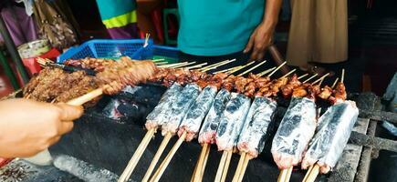 saziare buntel o satay buntel è satay fatto a partire dal tritato montone avvolto nel montone Grasso è essere grigliato su carbone foto