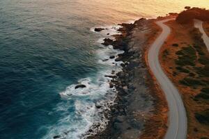 aereo Visualizza di un' avvolgimento strada nel il atlantico oceano a tramonto, aereo Visualizza di un' strada andando lungo il mare a tramonto, ai generato foto