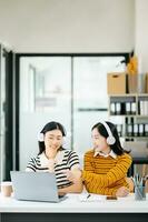 asiatico studenti siamo studiando il città universitaria parco. giovane persone siamo la spesa tempo insieme. lettura prenotare, Lavorando con computer portatile, tavoletta e comunicare mentre nel Università biblioteca foto