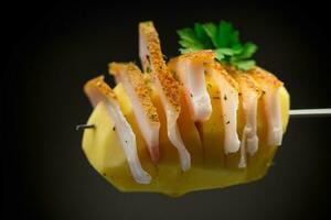 crudo patate preparato per cottura al forno, con lardo su nero sfondo foto