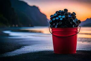 un' secchio pieno di nero plastica bottiglie su il spiaggia. ai-generato foto