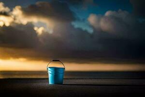 un' blu secchio si siede su il spiaggia a tramonto. ai-generato foto