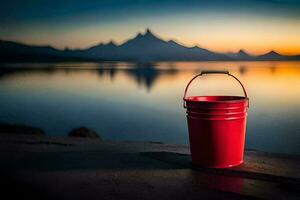 un' rosso secchio si siede su il riva di un' lago a tramonto. ai-generato foto