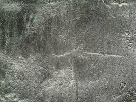 grungy parete di grigio calcestruzzo struttura con Cracked superficie a partire dal sabbia e cemento materiali. foto