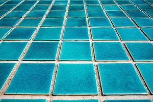 primo piano del pavimento piastrellato della piscina blu foto