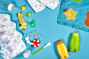 bambino cura con bagno impostare. capezzolo, giocattolo, pannolini, shampoo su blu sfondo superiore Visualizza modello foto