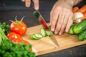 maschio mani taglio verdure per insalata foto